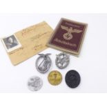 A COLLECTION OF FIVE GERMAN MILITARY BADGES TOGETHER WITH A NAZI STAMPED BORDER PASS(?) AND A
