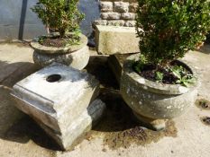 A PAIR OF CARVED STONE CIRCULAR GARDEN URNS ON ASSOCIATED PLINTH BASES.