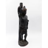 AN ANTIQUE CARVED STATUE OF A BOUND STANDING FIGURE. H.32cms.