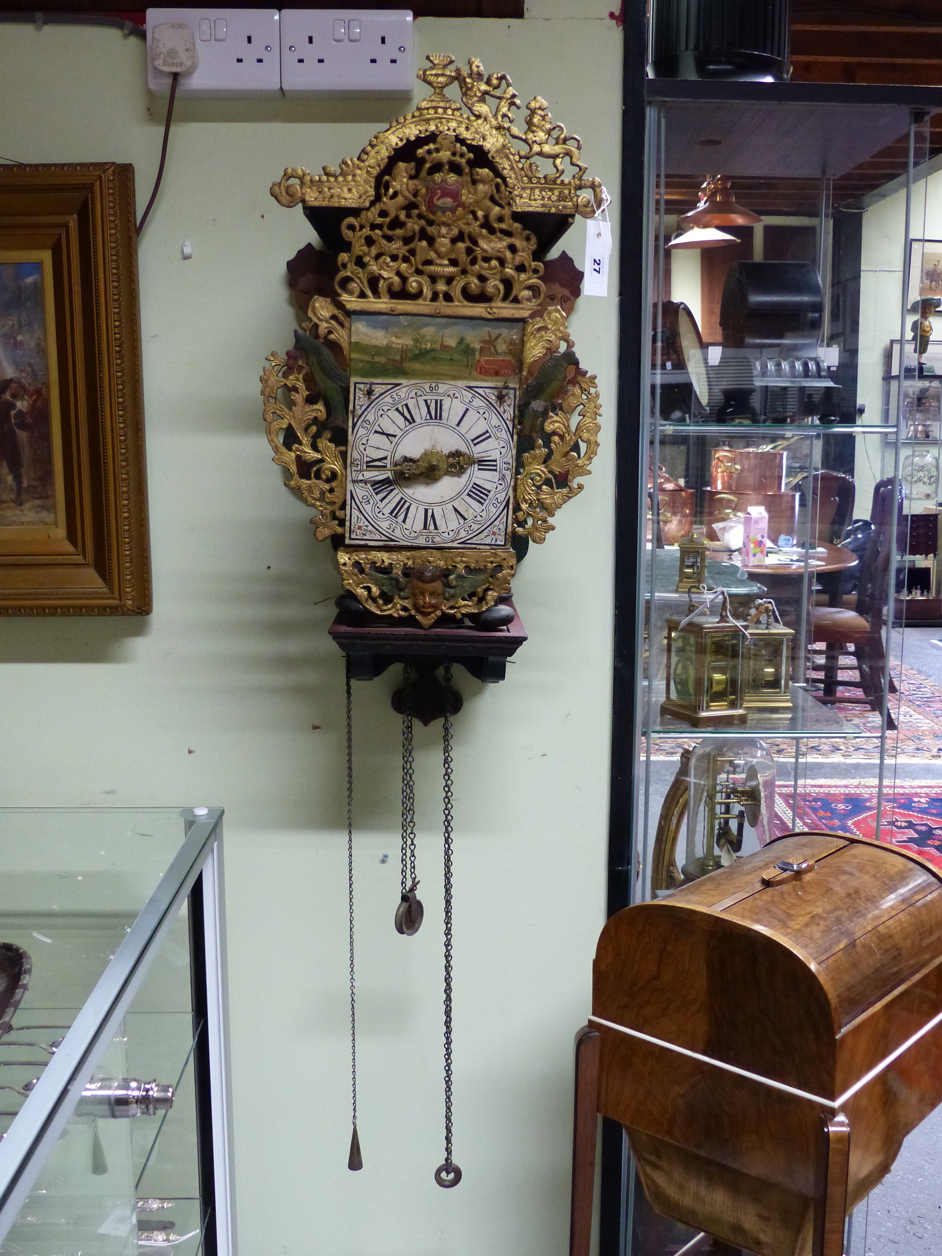 AN ANTIQUE DUTCH STAART WALL CLOCK WITH ORIGINAL PAINTED BRACKET AND PIERCED CAST METAL MOUNTS.