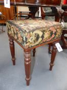 A REGENCY MAHOGANY STOOL WITH FLORAL NEEDLEPOINT SEAT AND RING TURNED TAPERED LEGS.