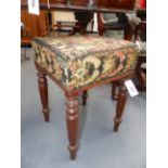 A REGENCY MAHOGANY STOOL WITH FLORAL NEEDLEPOINT SEAT AND RING TURNED TAPERED LEGS.