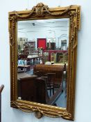 A CLASSICAL STYLE GILT FRAMED MIRROR. W.79 x H.120cms.