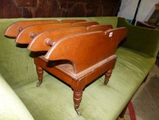 A VICTORIAN OAK CANTERBURY WITH BRASS CASTORS TOGETHER WITH A GERMANIC STYLE COFFEE TABLE. (2)