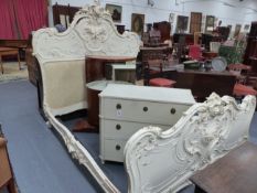 A FRENCH CARVED AND PAINTED ROCOCO STYLE DOUBLE BEDSTEAD, ELABORATE PIERCED HEAD AND FOOTBOARDS WITH