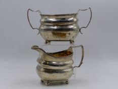 A GEORGIAN SILVER CREAMER AND MATCHING SUGAR BOWL WITH A GILT INTERIOR DATED 1812 LONDON.