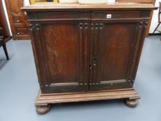 AN 18th.C.CONTINENTAL OAK LOW CABINET WITH PANEL DOORS ENCLOSING MULTI DRAWERS FITTED INTERIOR, SIDE