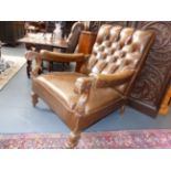 A PAIR OF EDWARDIAN BROWN LEATHER LIBRARY ARMCHAIRS WITH CARVED DECORATION IN THE 18th.C.TASTE.