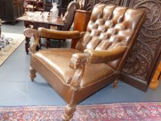 A PAIR OF EDWARDIAN BROWN LEATHER LIBRARY ARMCHAIRS WITH CARVED DECORATION IN THE 18th.C.TASTE.