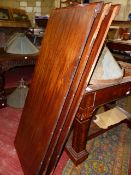 A VICTORIAN MAHOGANY WIND OUT DINING TABLE COMPLETE WITH HANDLE AND THREE LEAVES ON CARVED TURNED