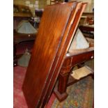 A VICTORIAN MAHOGANY WIND OUT DINING TABLE COMPLETE WITH HANDLE AND THREE LEAVES ON CARVED TURNED