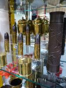 A GROUP OF VARIOUS TRENCH ART DECORATED SHELL CASES AND A PAIR OF TEA CANNISTERS WITH SWASTIKA