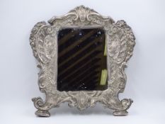 A WHITE METAL STAMPED 900 REPOUSSE ROCOCO STYLE MIRROR MOUNTED ON WOOD. APPROXIMATE MEASUREMENTS
