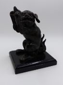 A JAPANESE BRONZE FIGURE OF A SEATED FOO LION. H.16cms.