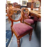 A SET OF SEVEN CARVED MAHOGANY VICTORIAN DINING CHAIRS WITH RING TURNED TAPERED LEGS.