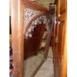 A 19th.C.GOTHIC OAK OVERMANTLE FRAME WITH INSET MIRROR PLATE. 124x145cms.