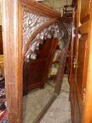 A 19th.C.GOTHIC OAK OVERMANTLE FRAME WITH INSET MIRROR PLATE. 124x145cms.