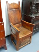 A CONTINENTAL OAK, ASH AND ELM COUNTRY LAMBING CHAIR WITH PANEL BACK.