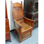 A CONTINENTAL OAK, ASH AND ELM COUNTRY LAMBING CHAIR WITH PANEL BACK.