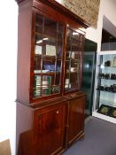 A LATE GEORGIAN MAHOGANY BOOKCASE CABINET WITH GLAZED DOORS OVER PANEL DOOR BASE. W.128 x H.222cms.