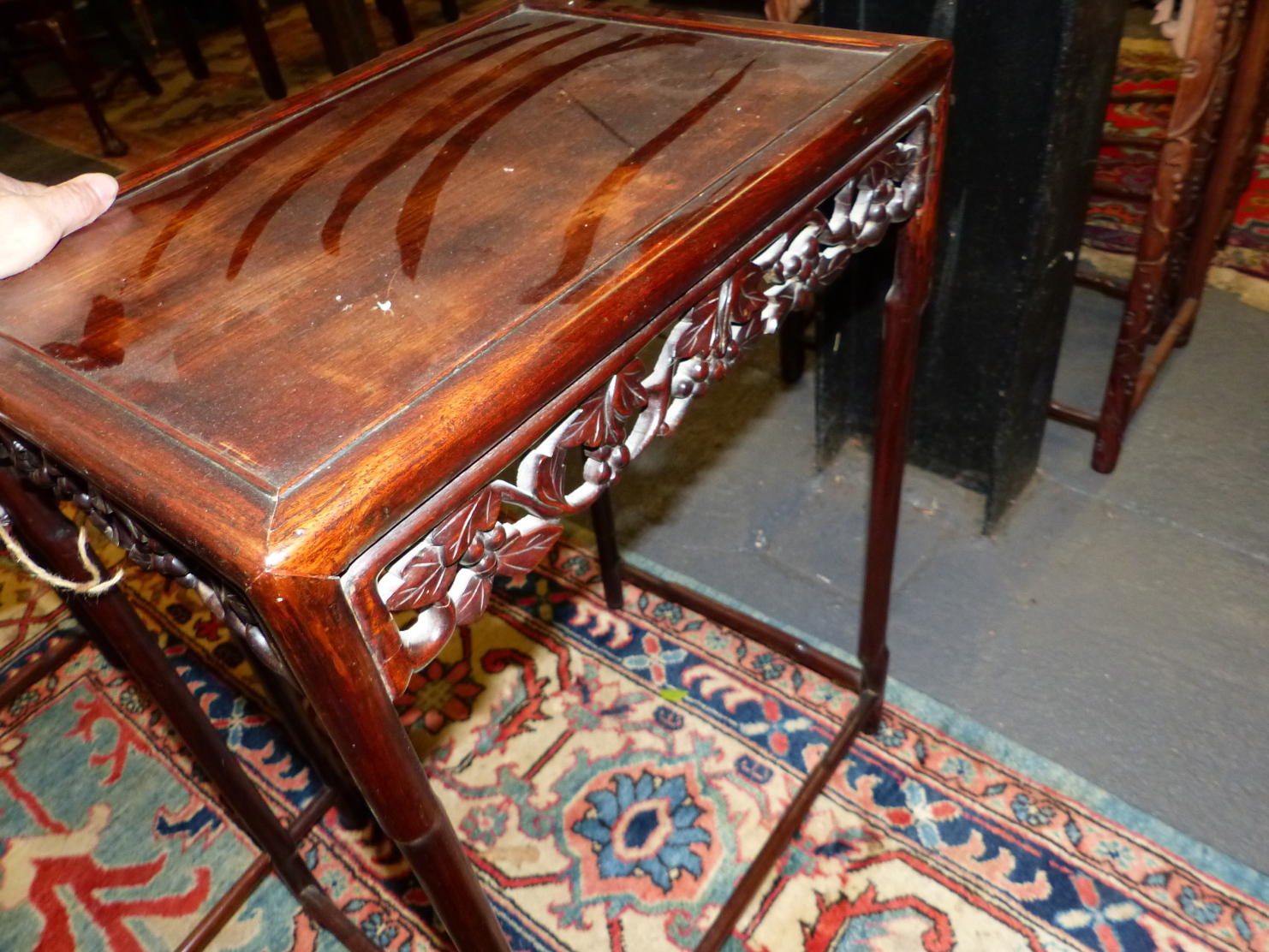 A NEST OF FOUR CHINESE CARVED HARDWOOD TABLES WITH PIERCED FOLIATE APRONS. - Image 19 of 19