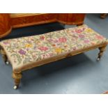 A VICTORIAN GILT FRAMED LONG STOOL WITH TAPESTRY TOP. L.118cms x W.49cms.