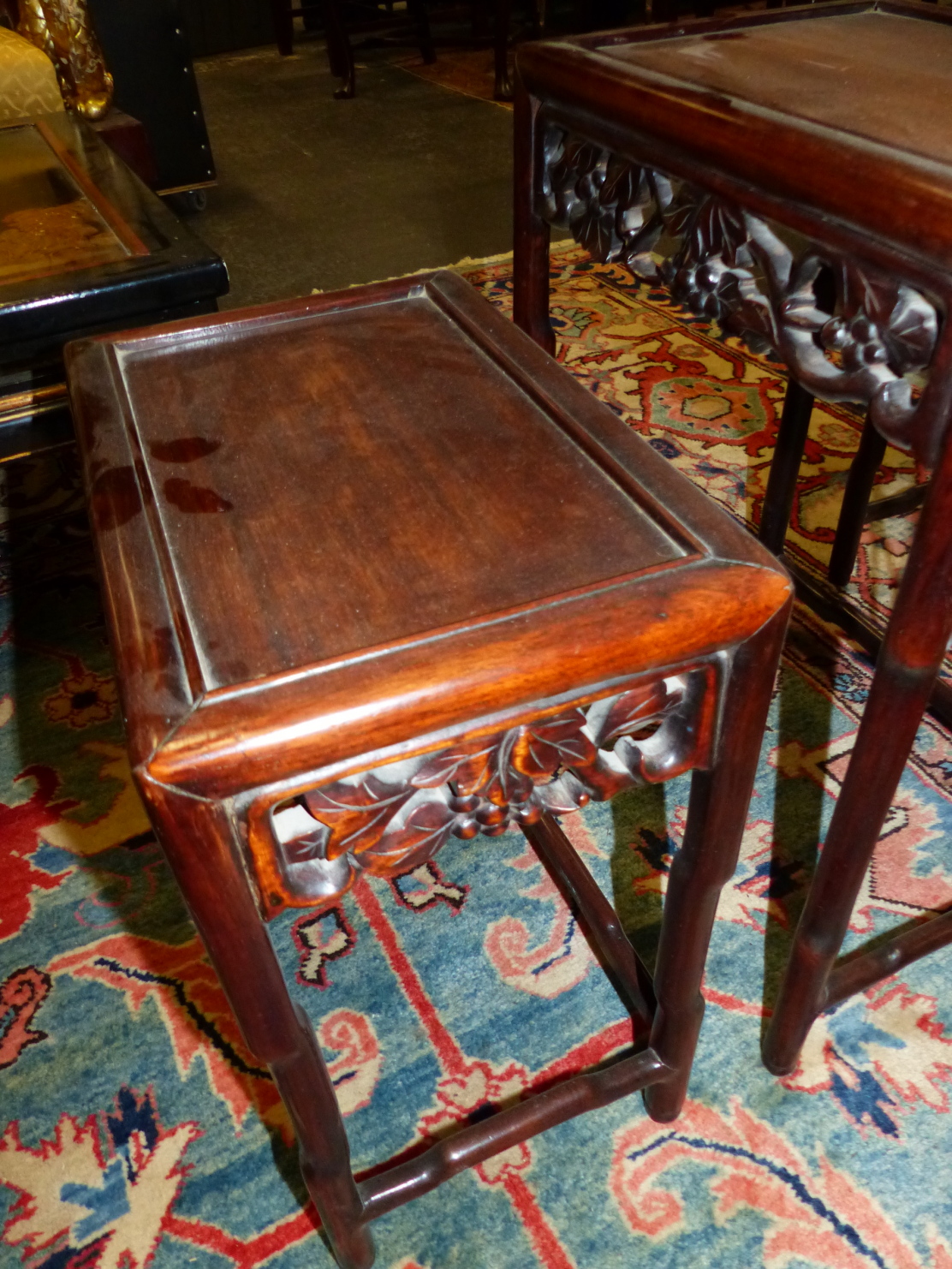 A NEST OF FOUR CHINESE CARVED HARDWOOD TABLES WITH PIERCED FOLIATE APRONS. - Image 7 of 19