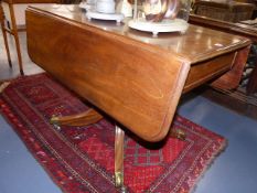 AN EARLY 19th.C.MAHOGANY PEMBROKE TABLE ON COLUMN SUPPORT, QUADROPED SPLAY LEGS AND BRASS CASTORS.