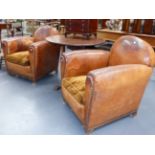 A PAIR OF FRENCH ART DECO BROWN LEATHER CLUB ARMCHAIRS WITH VELVET SEAT CUSHIONS.