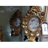 A PAIR OF ITALIAN GILTWOOD CARVED ROCOCO STYLE OVAL SMALL FRAMES WITH INSET PANELS OF FLORAL