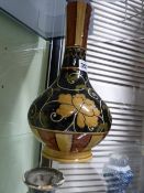 A WEDGWOOD BOTTLE FORM STUDIO POTTERY VASE WITH EASTERN STYLE SCROLLING FLORAL DECORATION. H.30cms.