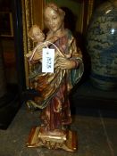 A CONTINENTAL CARVED AND POLYCHROME STANDING FIGURAL GROUP OF THE MADONNA AND CHILD WITH GILT