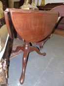 AN UNUSUAL INLAID MAHOGANY GEORGIAN AND LATER DROP LEAF REVOLVING TOP LAMP TABLE WITH SHAPED TOP AND