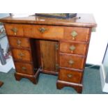 A SMALL INLAID WALNUT EARLY GEORGIAN AND LATER KNEEHOLE DESK WITH FRIEZE DRAWER ABOVE TWO BANKS OF