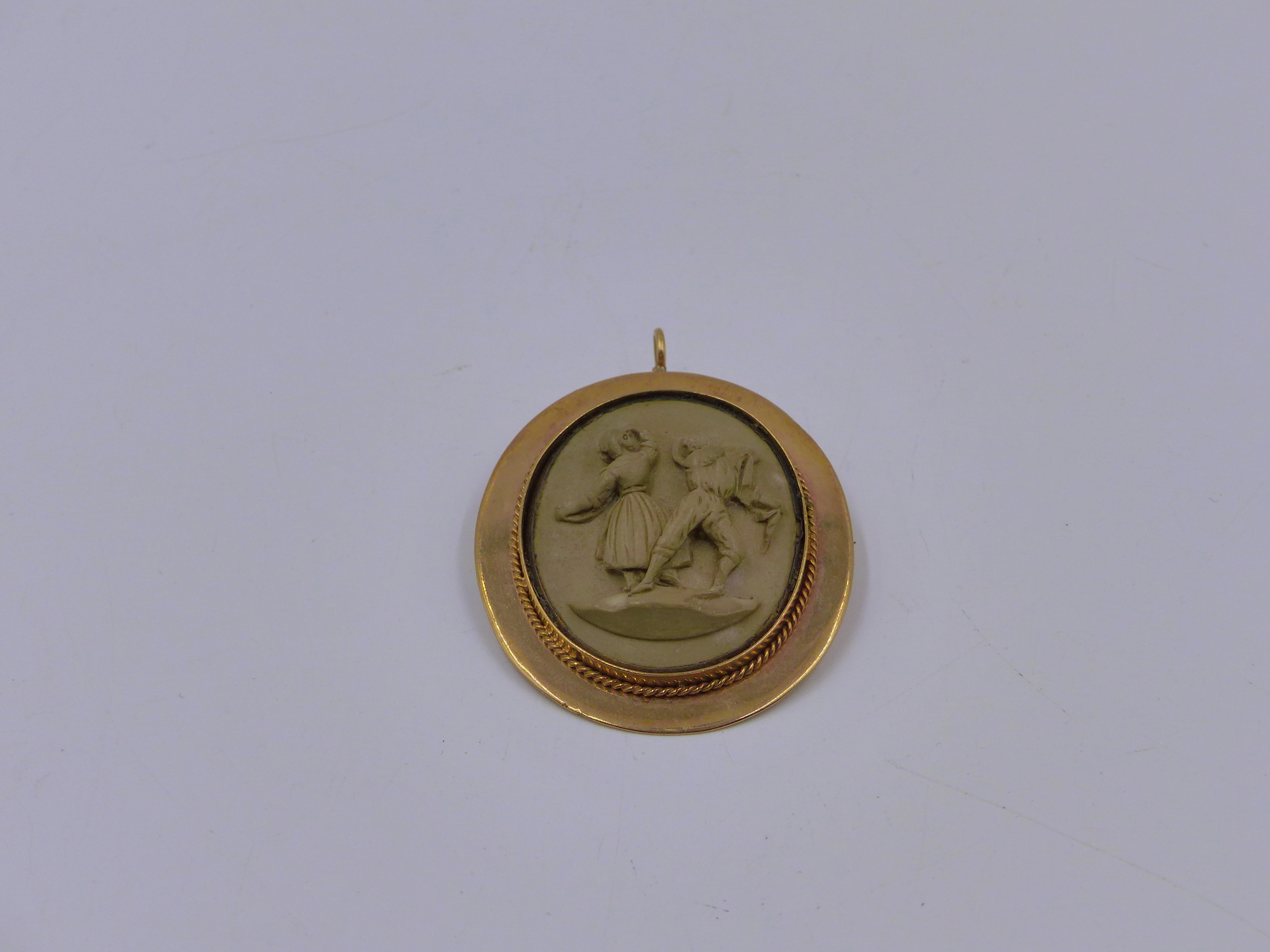 A VICTORIAN RAISED RELIEF LAVA CAMEO OF A FIGURAL SCENE SET IN A 9ct. STAMPED BROOCH AND PENDANT