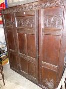 AN 18th.C.OAK PANELLED HALL OR LIVERY CUPBOARD WITH SINGLE DOOR. W.142cms.