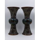 A PAIR OF CLOISONNE TRUMPET FORM VASES WITH BULBOUS WAISTS, WRITHING DRAGONS AND LOTUS DECORATION