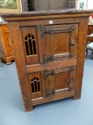 A 17th.C.AND LATER OAK LOW FOOD CUPBOARD WITH TWO DOORS, IRON STRAPPED HINGES AND INSET PIERCED