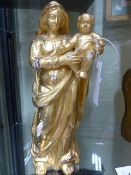 AN EARLY CONTINENTAL CARVED GILTWOOD STANDING FIGURE OF THE MADONNA AND CHILD. H.30cms.