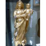 AN EARLY CONTINENTAL CARVED GILTWOOD STANDING FIGURE OF THE MADONNA AND CHILD. H.30cms.