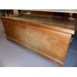 A LARGE ELM BLANKET CHEST ON PLINTH BASE. W.112cms.