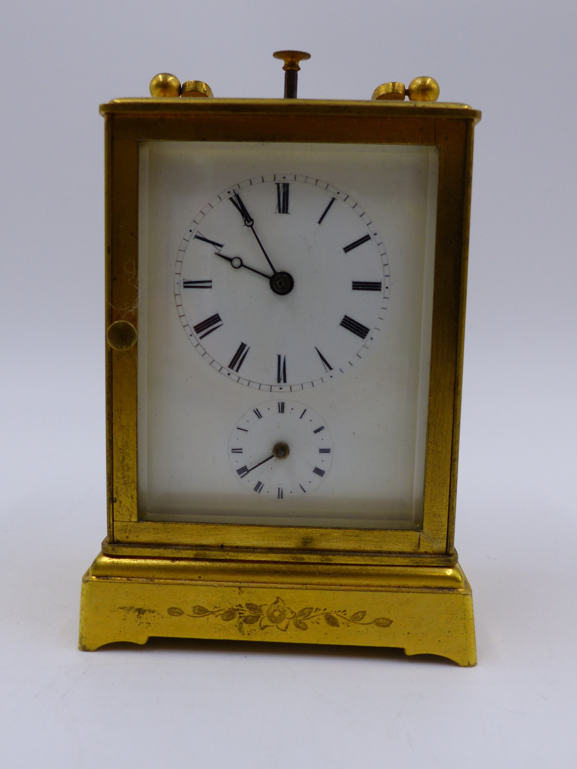 A SMALL GILT BRASS CASED DRESSING TABLE OR BEDSIDE CLOCK WITH ALARM AND PUSH 1/4 REPEAT BELL