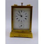 A SMALL GILT BRASS CASED DRESSING TABLE OR BEDSIDE CLOCK WITH ALARM AND PUSH 1/4 REPEAT BELL