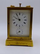 A SMALL GILT BRASS CASED DRESSING TABLE OR BEDSIDE CLOCK WITH ALARM AND PUSH 1/4 REPEAT BELL