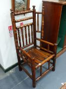 AN EARLY COUNTRY ASH SPINDLE WING BACK COTTAGE CHAIR.