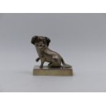 A CHINESE EXPORT WHITE METAL FIGURE OF A SEATED DOG, ENGRAVED POOR PAT PEITAIHO, 1923. APPROXIMATE