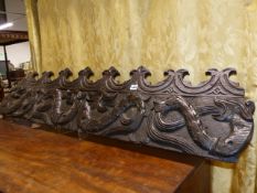 A 17th/18th.C CARVED OAK FRIEZE PANEL SECTION DEPICTING SEA SERPENTS. W.136cms.
