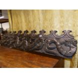 A 17th/18th.C CARVED OAK FRIEZE PANEL SECTION DEPICTING SEA SERPENTS. W.136cms.