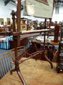 A VICTORIAN MAHOGANY TAPESTRY FRAME WITH RING TURNED SUPPORTS AND CURVED LEGS.