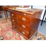 A MAHOGANY GEORGIAN STYLE SMALL THREE DRAWER CHEST WITH BRUSHING SLIDE STANDING ON BRACKET FEET.